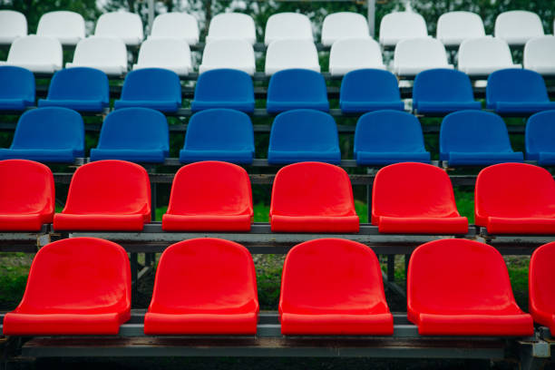 istock Blue Red White Seats On Stadium close up 1163933762