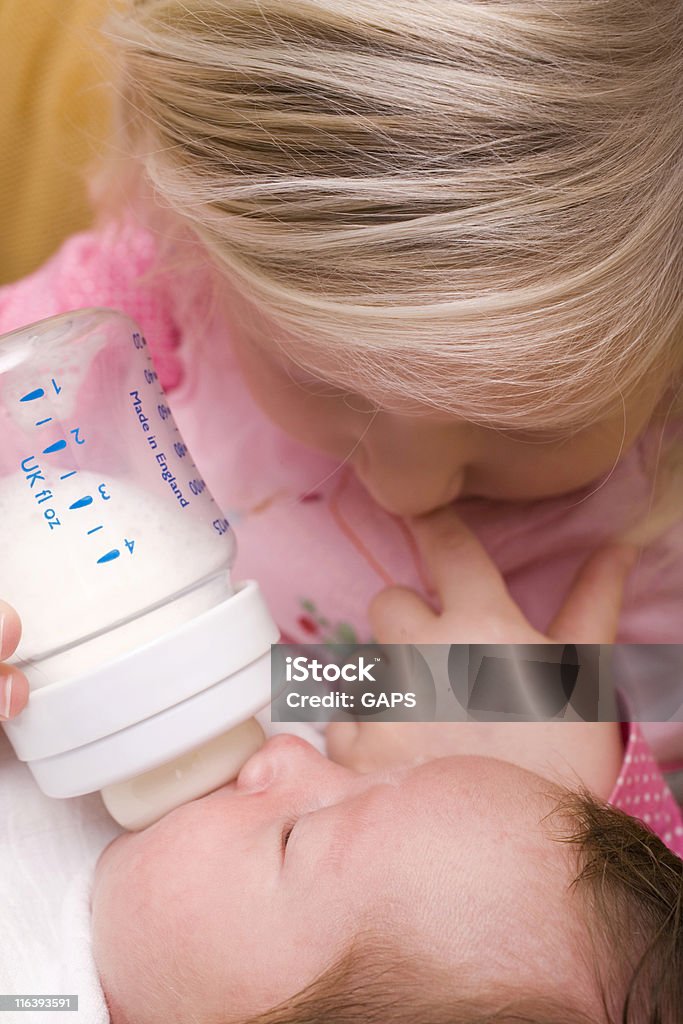 Blondes Mädchen, die Fütterung Ihr Neugeborenes Bruder - Lizenzfrei 0-11 Monate Stock-Foto