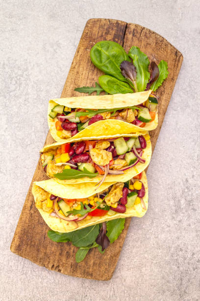 istock Mexican taco with chicken meat, red beans, fresh vegetables 1163936322