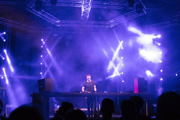 istock Dj playing techno music on the stage 1163942745