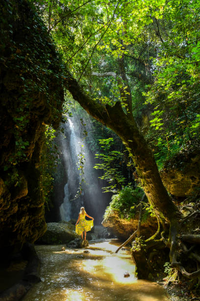 istock The woman at the waterfall. 1163951595