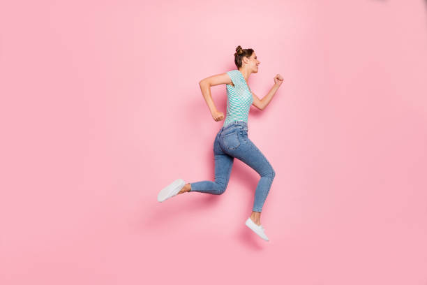 istock Full length body size profile side view of her she nice-looking lovely charming slender strong purposeful cheerful cheery girl hurrying isolated over pink pastel background 1163954396