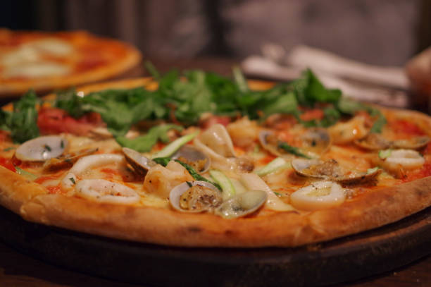 istock Seafood pizza with shrimp, squid, clam and lettuce topping 1163954419
