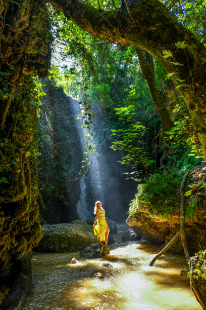 istock The woman at the waterfall. 1163954665