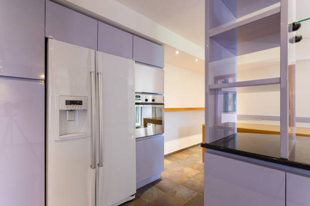 Modern lilac kitchen in luxury loft with modern appliances. No one inside