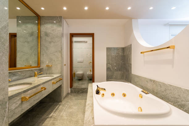 istock Luxury bathroom with large hydromassage, green marble and gold sinks 1163954897