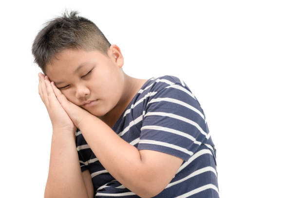 istock Obese fat boy sleep isolated on white background 1163956083