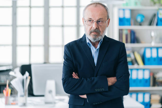 istock Confident senior businessman leader at office 1163956156