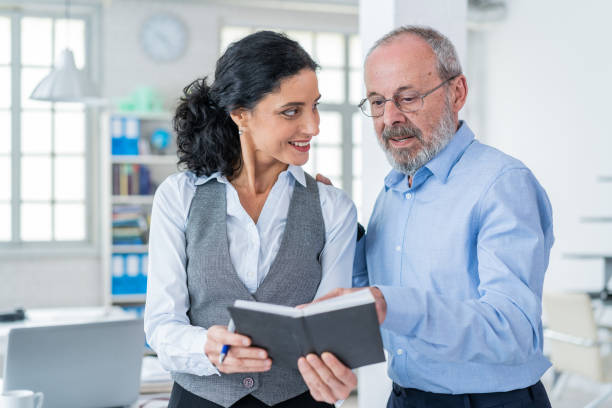 istock Senior male manager working with his assistant secretary 1163956169