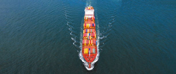 istock Aerial side view container ship carrying container in import export business logistic and transportation of international by container ship in the open sea, with copy space. 1163959904