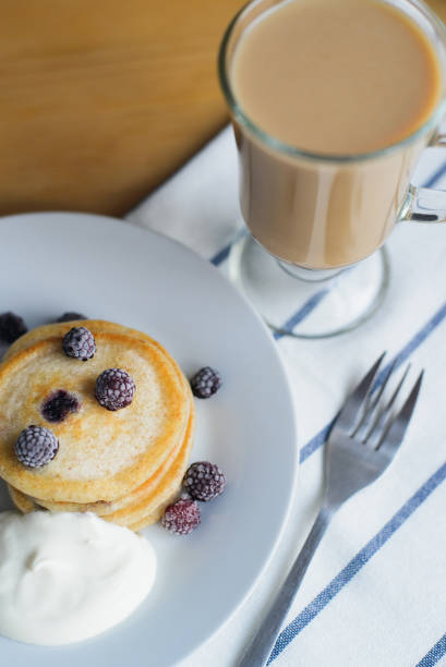istock oladyi or pancakes with black raspberry with smetana on plate 1163962831