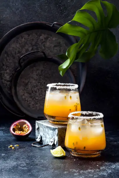 Mango passionfruit margarita cocktail with lime. Tropical alcoholic drink for summer party