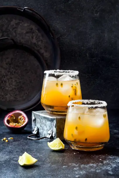 Mango passionfruit margarita cocktail with lime. Tropical alcoholic drink for summer party
