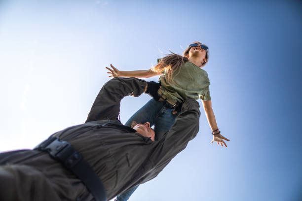 Directly below father holding daughter high over head