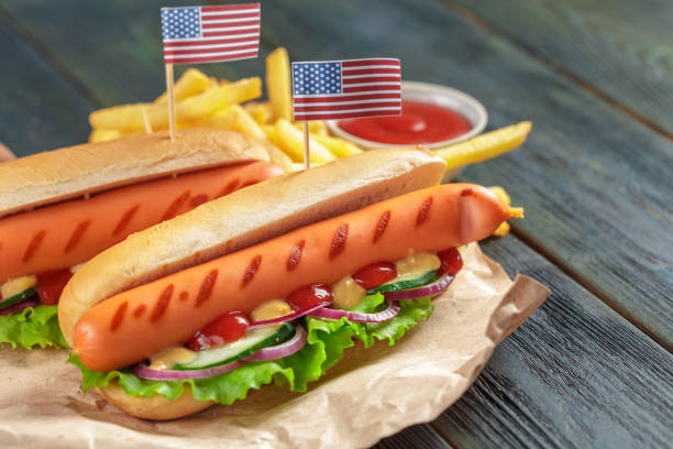 istock Hot dogs on wooden background 1163964465