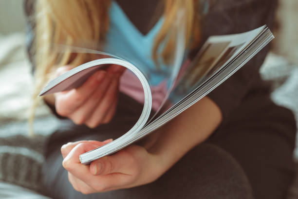 woman reading magazine at home