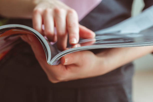 istock woman reading magazine at home 1163964550