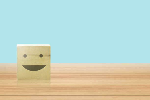 istock Wooden geometric shapes cube with emoticon 1163964768