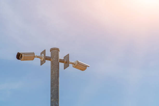istock CCTV on the pole with blue sky background 1163964844