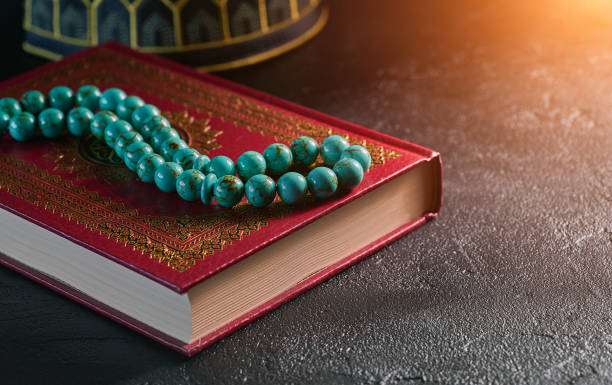 istock Islamic book Koran with rosary beads on grey stone background 1163965498