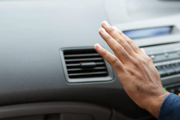 istock Closeup of hand driver man checking adjusting air from conditioning the cooling system with flow of cold air in car. Leave space for writing text. 1163966066