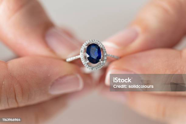 Woman Holding A Blue Diamond Ring Stock Photo - Download Image Now - Sapphire, Ring - Jewelry, Engagement Ring