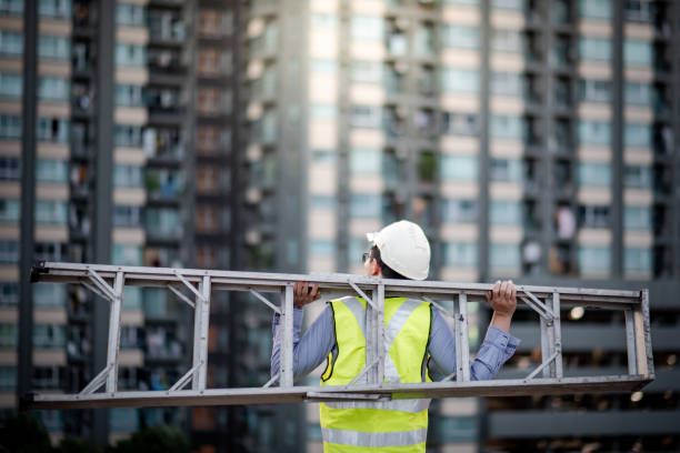 istock Maintenance worker man carrying aluminium ladder 1163967074