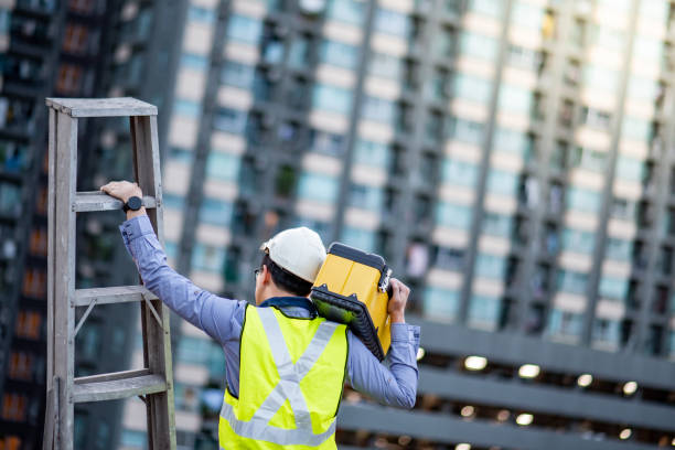 istock Worker man carrying aluminium ladder and tool box 1163967189