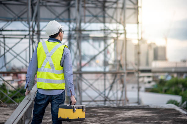 istock Worker man carrying aluminium ladder and tool box 1163967541