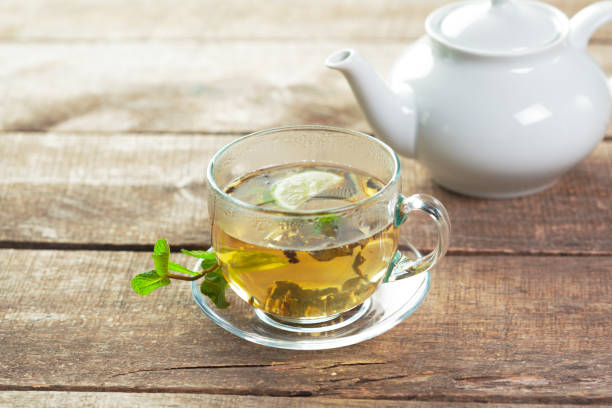 istock cup of black tea with mint leaves on a wooden table 1163967712