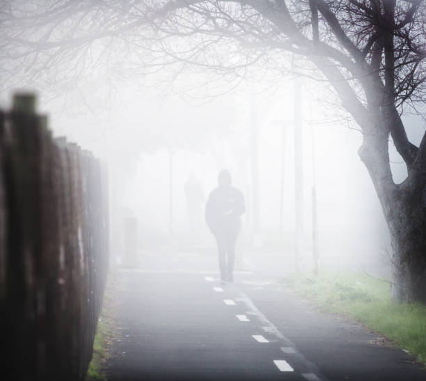 istock Ghostly pedestrian trudging to work in morning fog 1163967765
