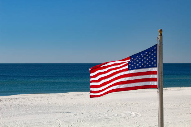 With the American flag waving, enjoy cups of coffee on the porch of a favorite beach house in Carpinteria, CA.
