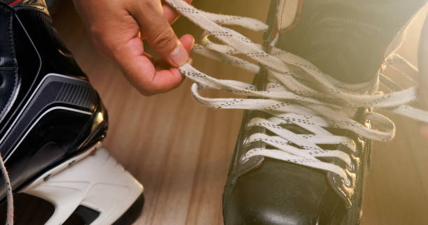 istock Pro Ice hockey, He shoe stringer in the athlete's dressing room 1163970689