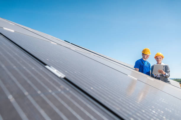istock Worker and investor in solar power plant 1163971390
