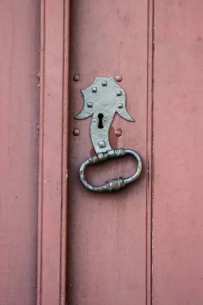 Doorknocker on red door.