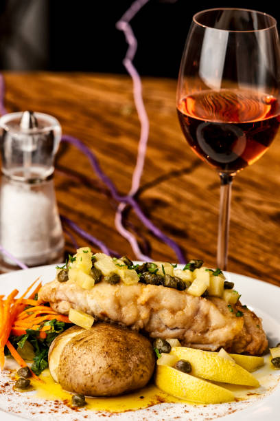 istock Beautiful cod dish with glass of wine. 1163972956