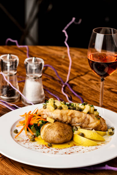 istock Beautiful cod dish with glass of wine. 1163973098