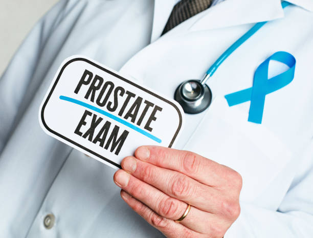 istock Doctor with stethoscope in white lab coat holding sign for prostate exam 1163976056