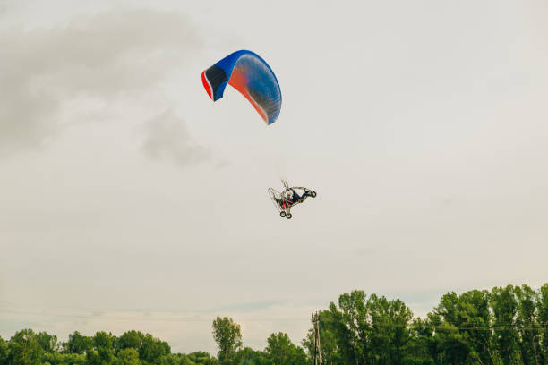 istock Alone paraglider flying in the sky 1163976469