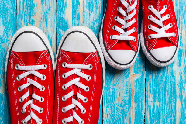 istock red sneakers on wooden background. 1163978065