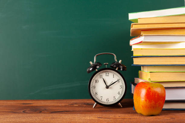 istock back to school - apple and books with pencils and blackboard 1163979483
