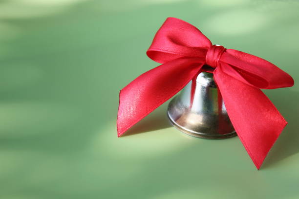 istock School bell with a red bow close-up. 1163979564