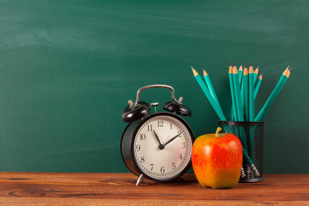 istock back to school - apple and books with pencils and blackboard 1163979696