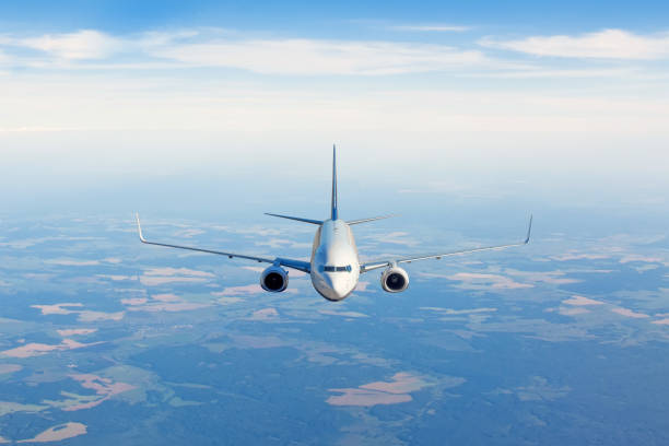 Passenger jet airplane flying in clear sky to destination.
