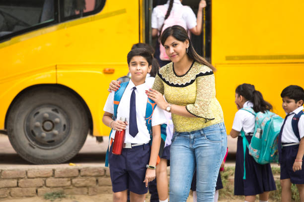 istock Teacher talking with student before they get on school bus 1163980655