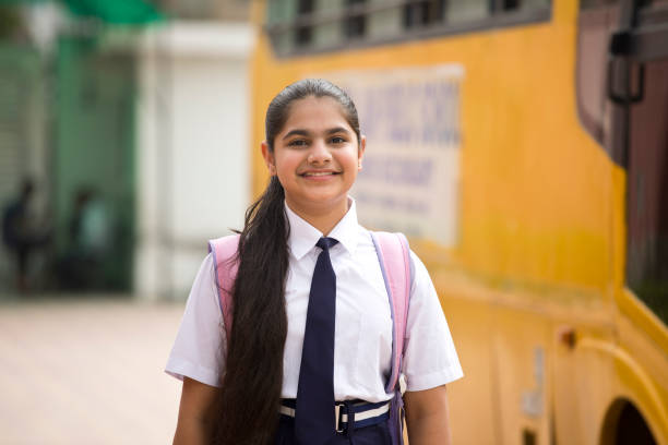 Portrait Of Schoolgirl In Uniform With Bag And Water Bottle Stock Photo - Download Image Now - iStock