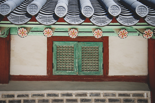 Front view of house facade in Korea. Typical window details and roof design.