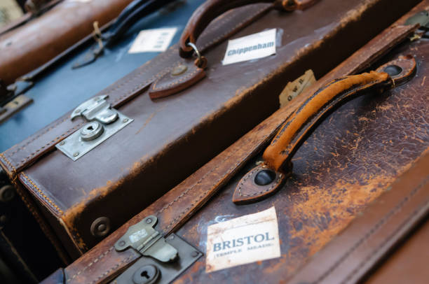 istock Old fashioned leather luggage cases with destination stickers 1163984718