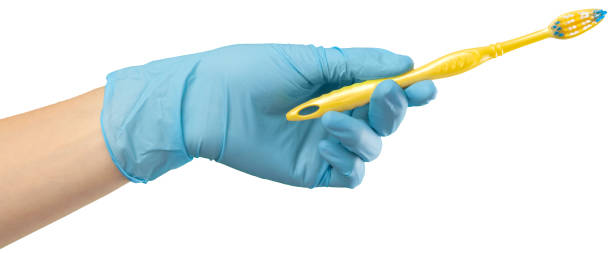 istock Toothbrush in the gloved hand 1163984863