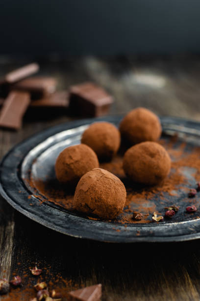 istock dark chocolate candy truffles with sichuan pepper on dark background 1163985098
